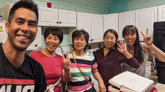 A group of five people taking a selfie photo